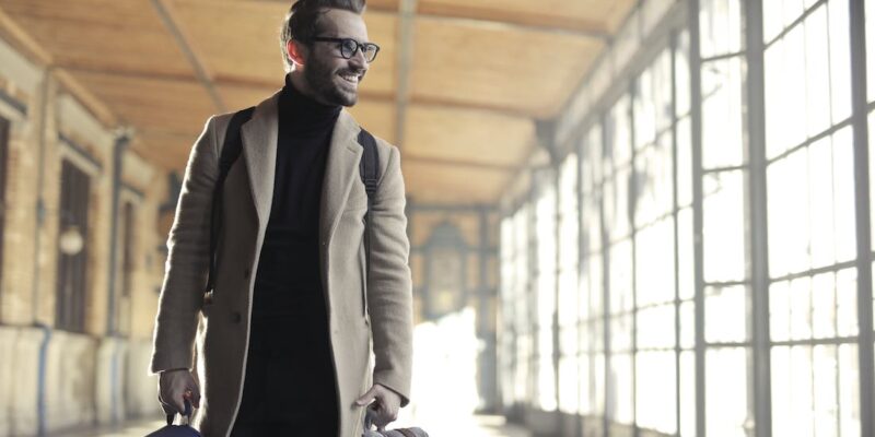 Free Man in Brown Robe Carrying Bag Smiling Stock Photo