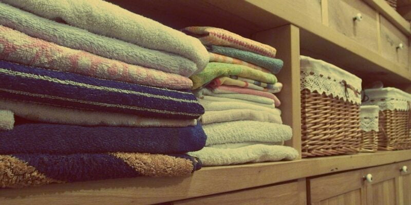 A stack of towels on a shelf Description automatically generated