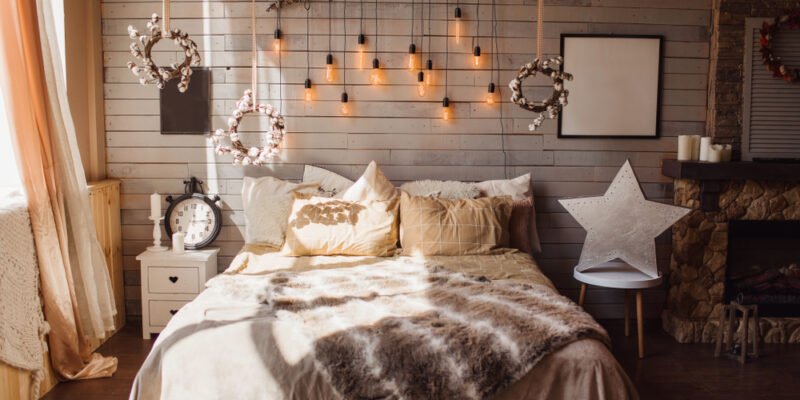 Cosy bedroom with eco decor. Wood and nature concept in interior of room. Scandinavian interior, real photo. Hygge decoration.